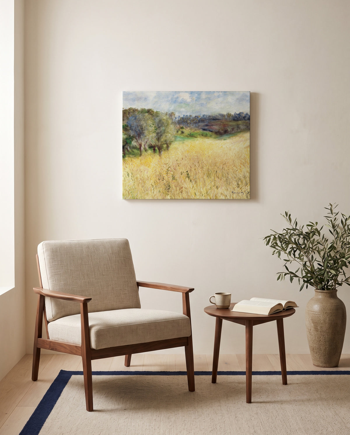 Wheatfield by Pierre-Auguste Renoir as a stretched canvas above a linen lounge chair in a reading corner