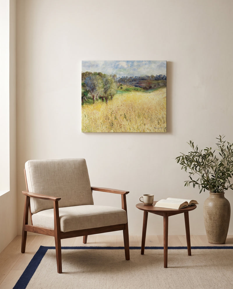 Wheatfield by Pierre-Auguste Renoir as a stretched canvas above a linen lounge chair in a reading corner