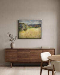 Wheatfield by Pierre-Auguste Renoir in a black frame above a walnut sideboard in a dining room