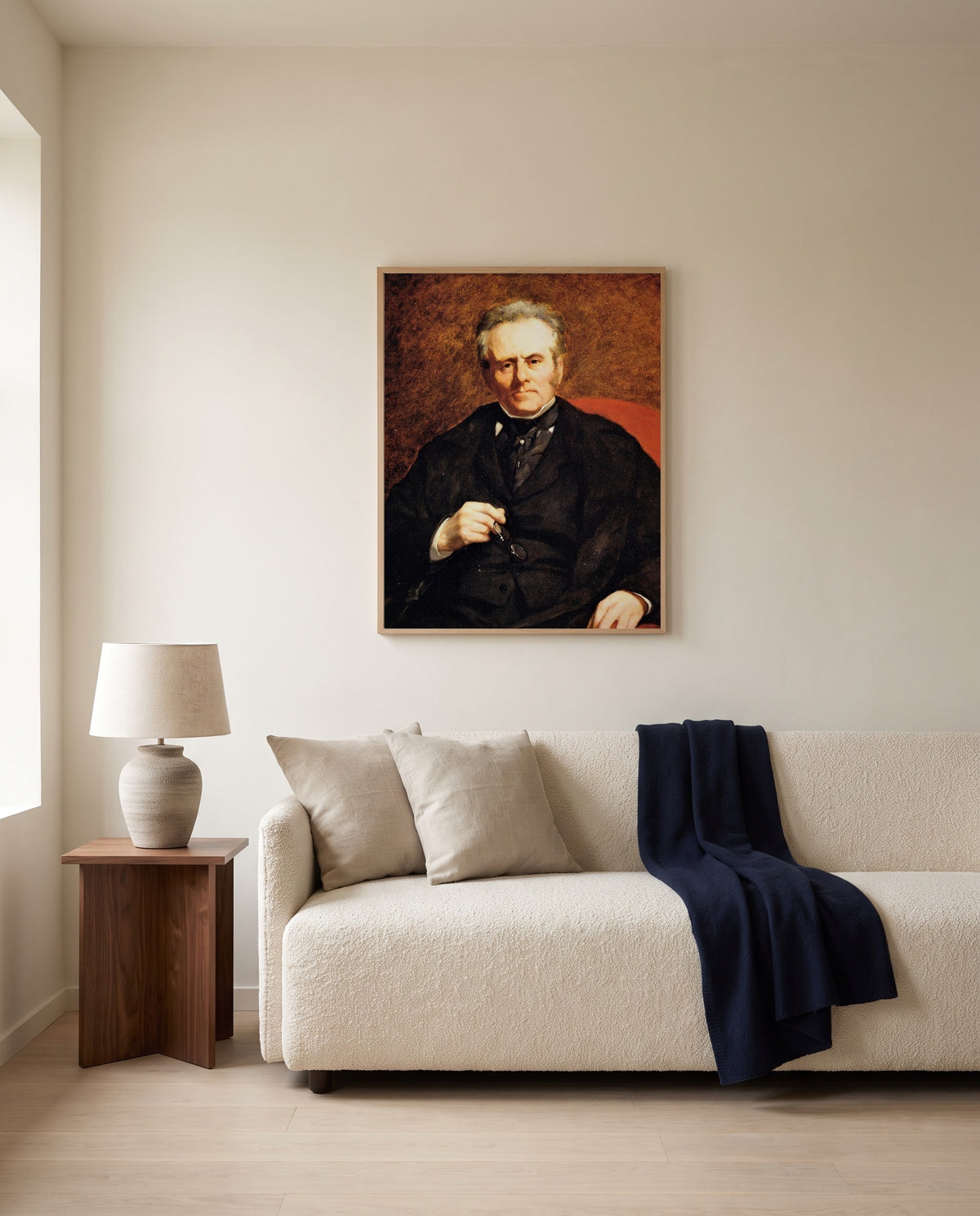 William Sisley by Pierre-Auguste Renoir framed in natural oak above a cream sofa in a warm living room