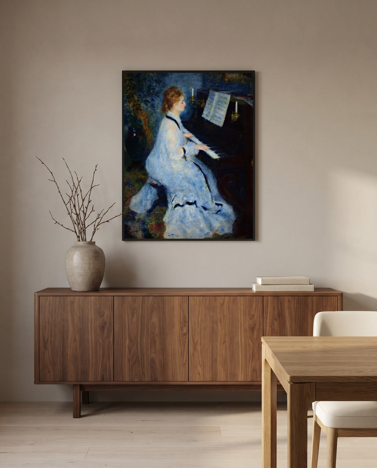 Woman at the Piano by Pierre-Auguste Renoir in a black frame above a walnut sideboard in a dining room