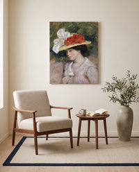 Woman in a Flowered Hat by Pierre-Auguste Renoir as a stretched canvas above a linen lounge chair in a reading corner