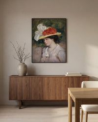Woman in a Flowered Hat by Pierre-Auguste Renoir in a black frame above a walnut sideboard in a dining room