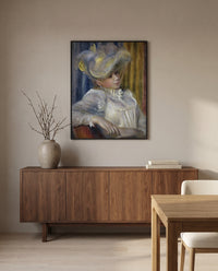 Woman with a Hat by Pierre-Auguste Renoir in a black frame above a walnut sideboard in a dining room