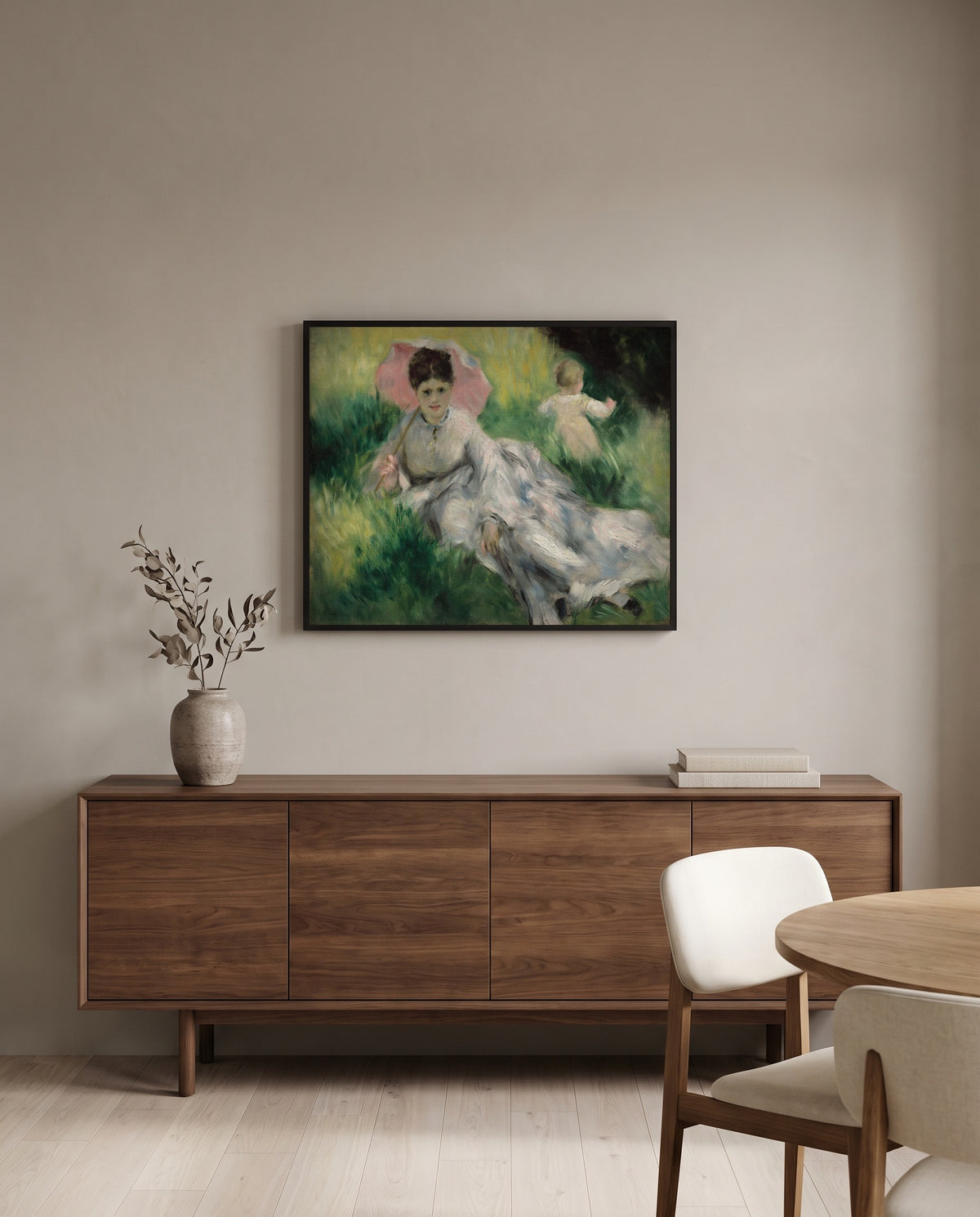 Woman with Parasol and Child by Pierre-Auguste Renoir in a black frame above a walnut sideboard in a dining room