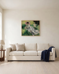 Woman with Parasol and Child by Pierre-Auguste Renoir framed in natural oak above a cream sofa in a warm living room