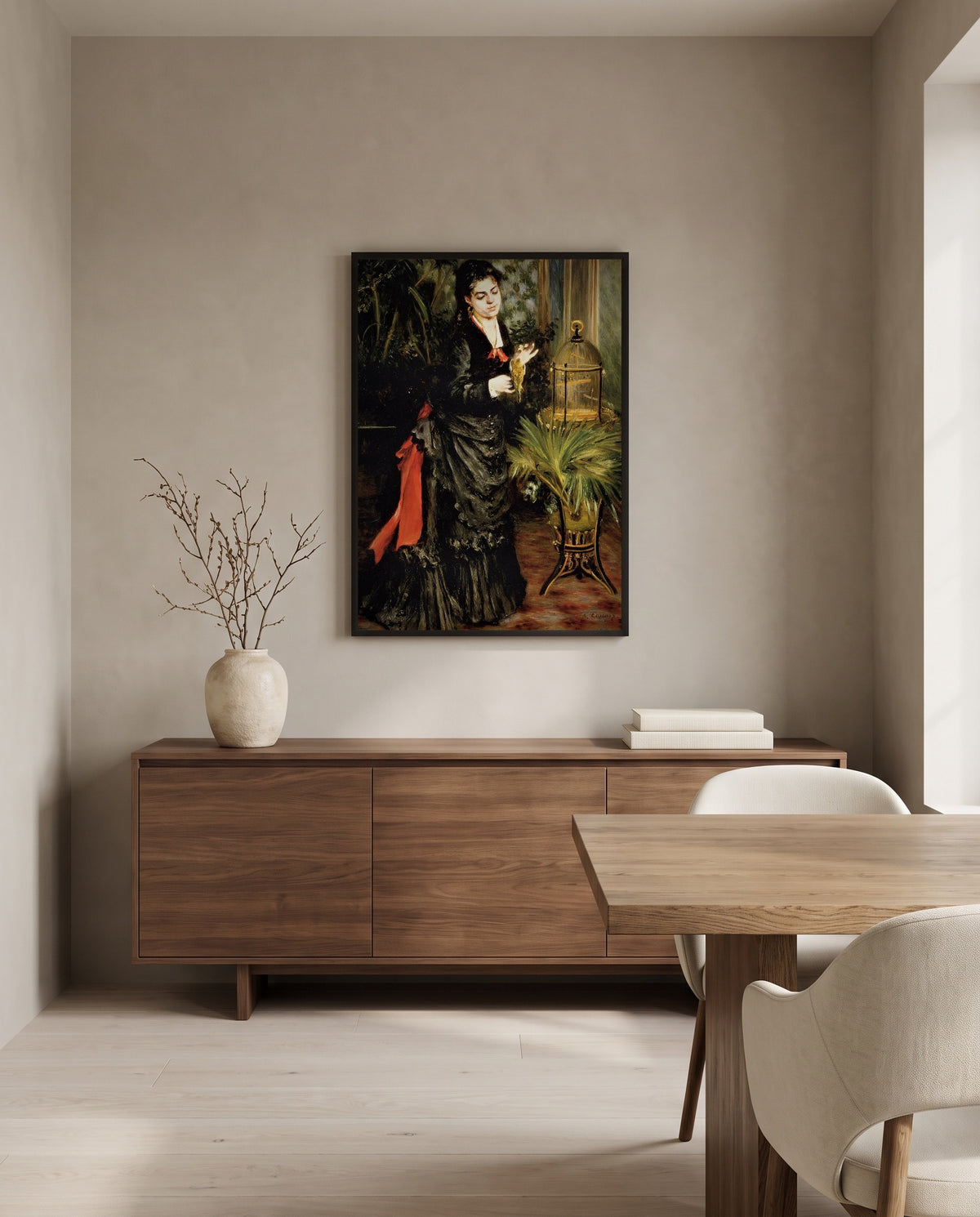 Woman with a Parrot by Pierre-Auguste Renoir in a black frame above a walnut sideboard in a dining room