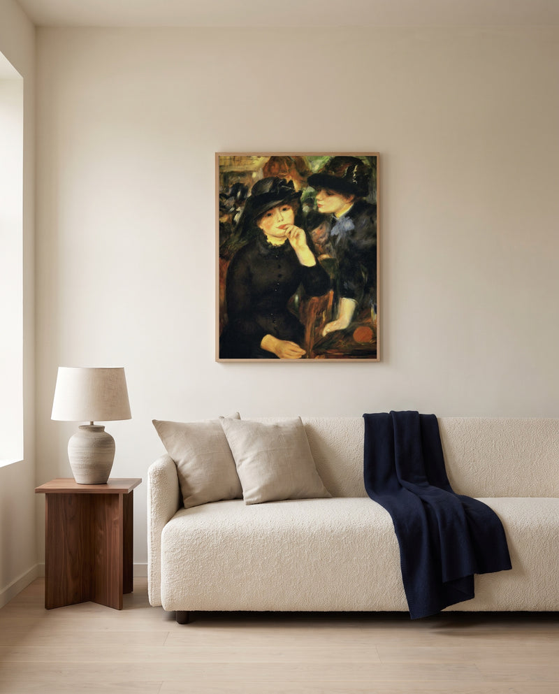 Young Women in Black by Pierre-Auguste Renoir framed in natural oak above a cream sofa in a warm living room