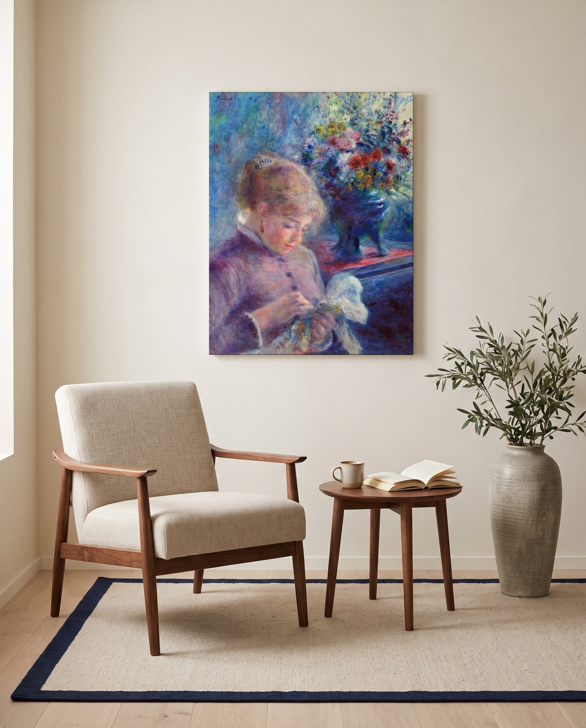 Young Woman Sewing by Pierre-Auguste Renoir as a stretched canvas above a linen lounge chair in a reading corner