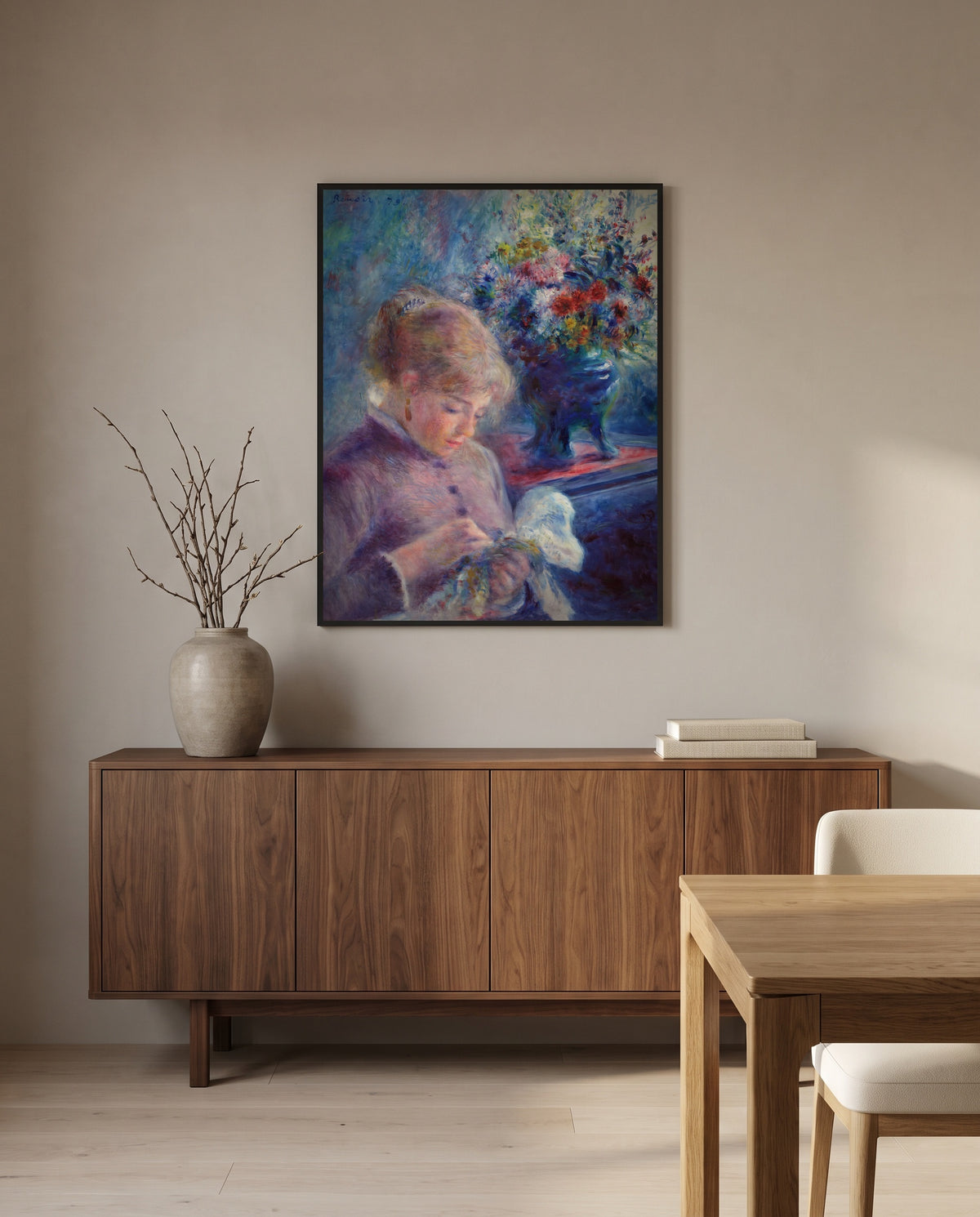 Young Woman Sewing by Pierre-Auguste Renoir in a black frame above a walnut sideboard in a dining room