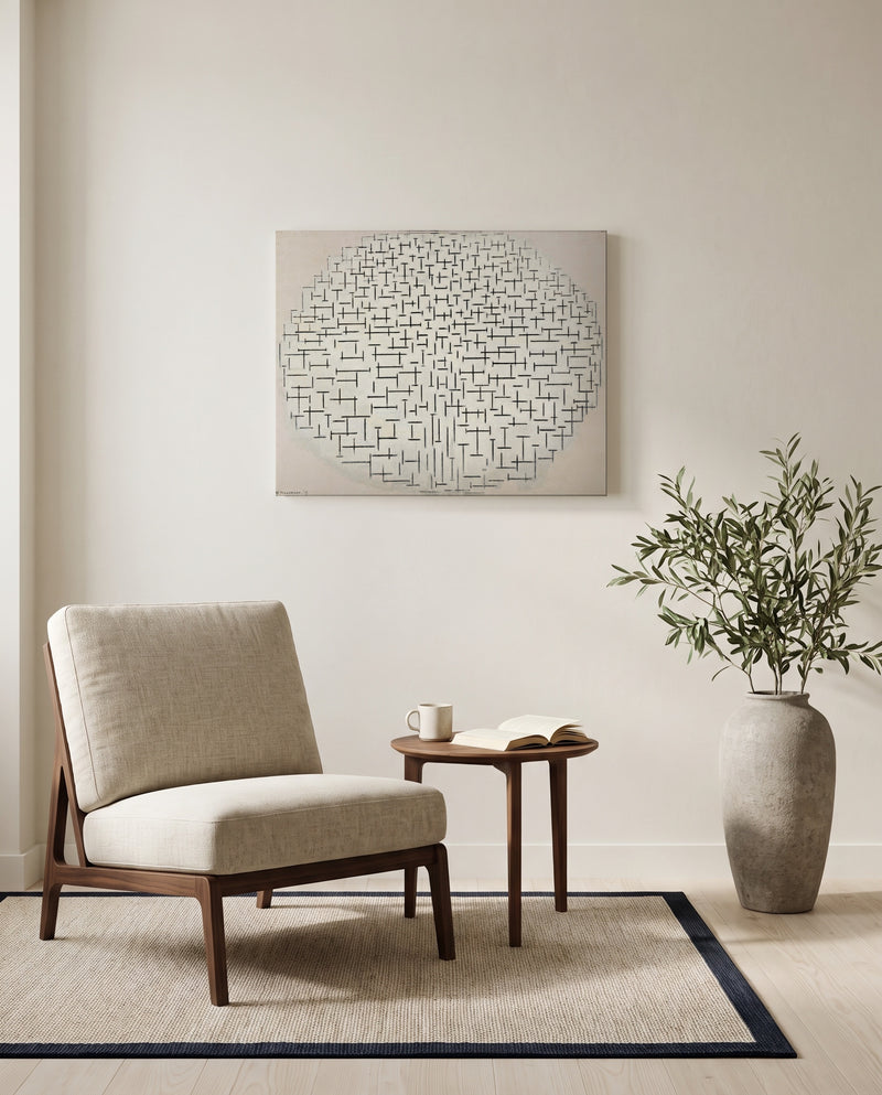 Composition 10 by Piet Mondrian as a stretched canvas above a linen lounge chair in a reading corner