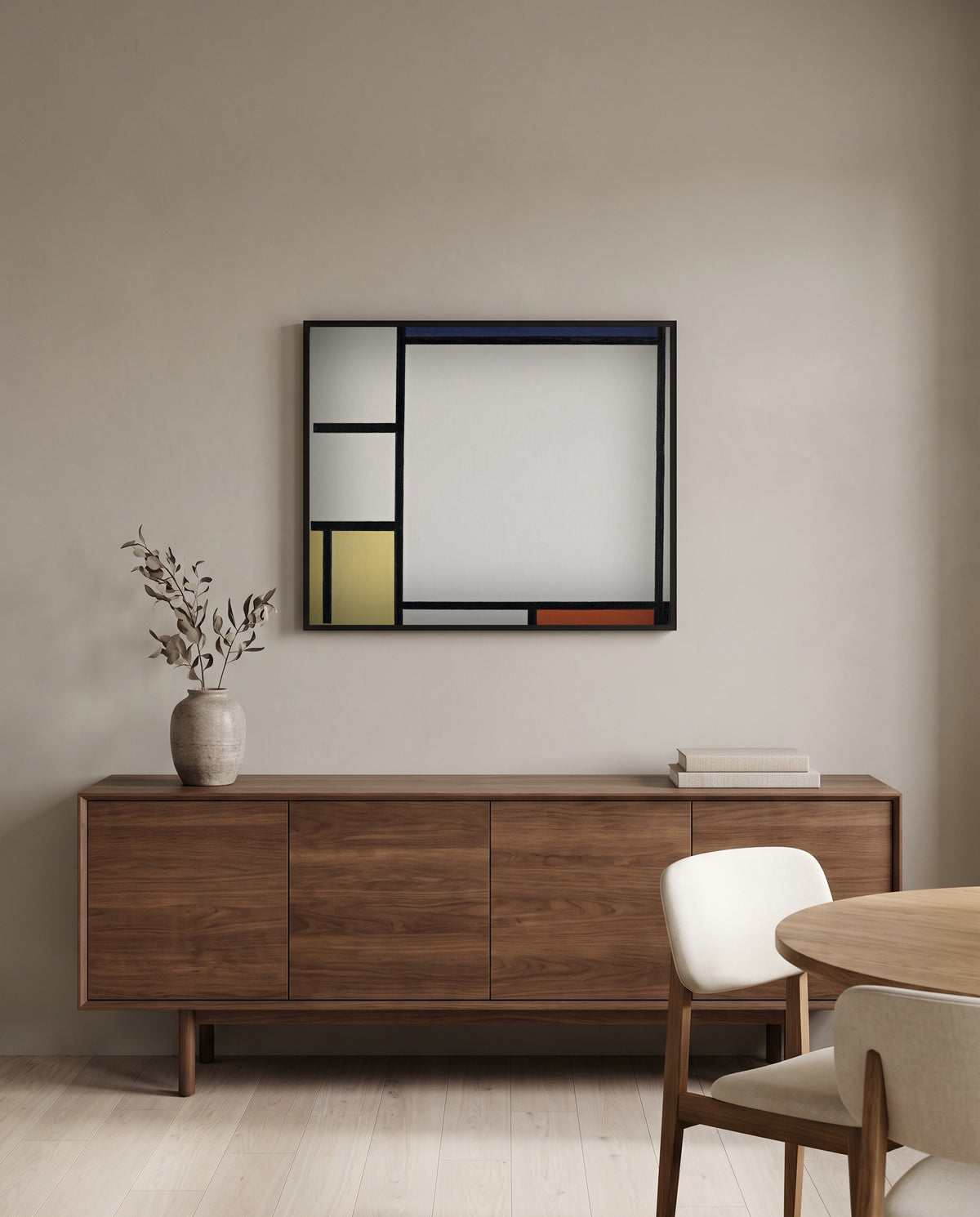 Blue, Red, Yellow and Black by Piet Mondrian in a black frame above a walnut sideboard in a dining room