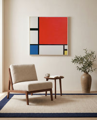 Composition II by Piet Mondrian as a stretched canvas above a linen lounge chair in a reading corner