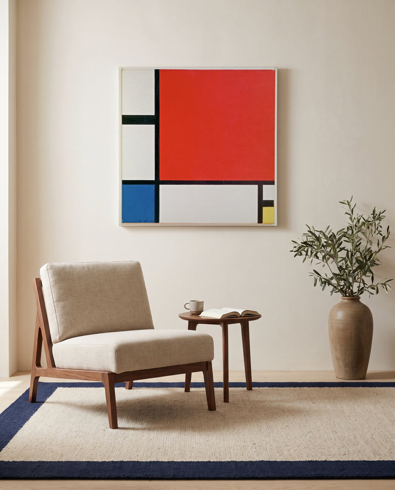 Composition II by Piet Mondrian as a stretched canvas above a linen lounge chair in a reading corner