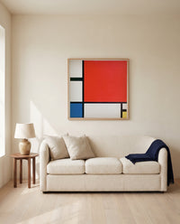 Composition II by Piet Mondrian framed in natural oak above a cream sofa in a warm living room