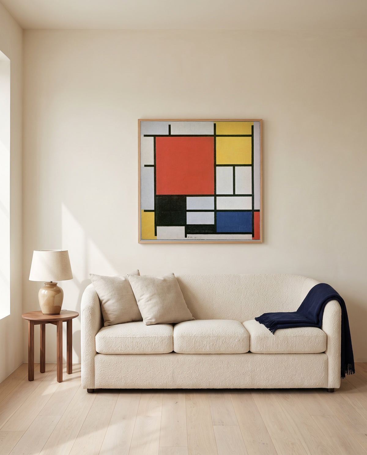 Large Red Plane by Piet Mondrian framed in natural oak above a cream sofa in a warm living room