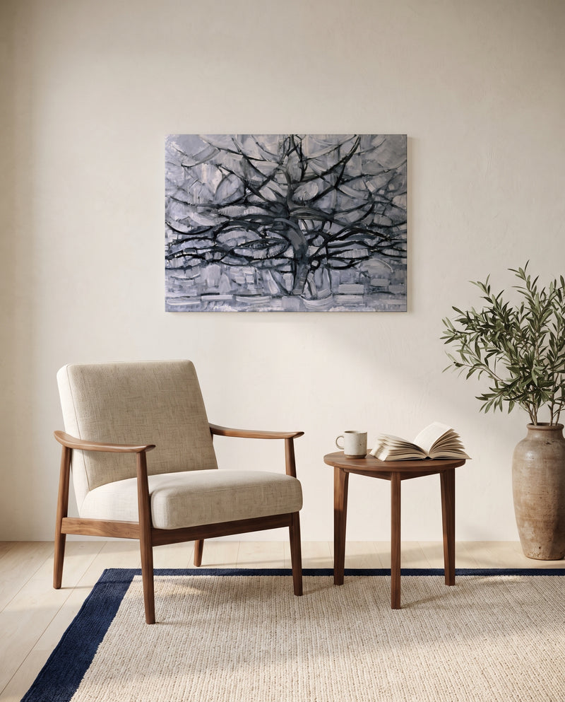 Gray Tree by Piet Mondrian as a stretched canvas above a linen lounge chair in a reading corner