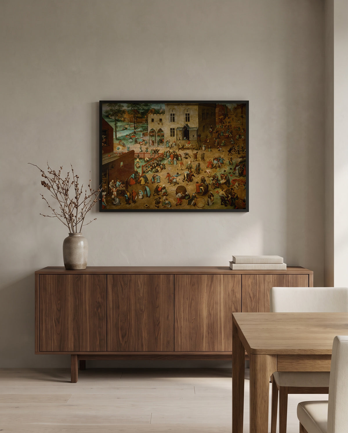 Children’s Games by Pieter Bruegel the Elder in a black frame above a walnut sideboard in a dining room