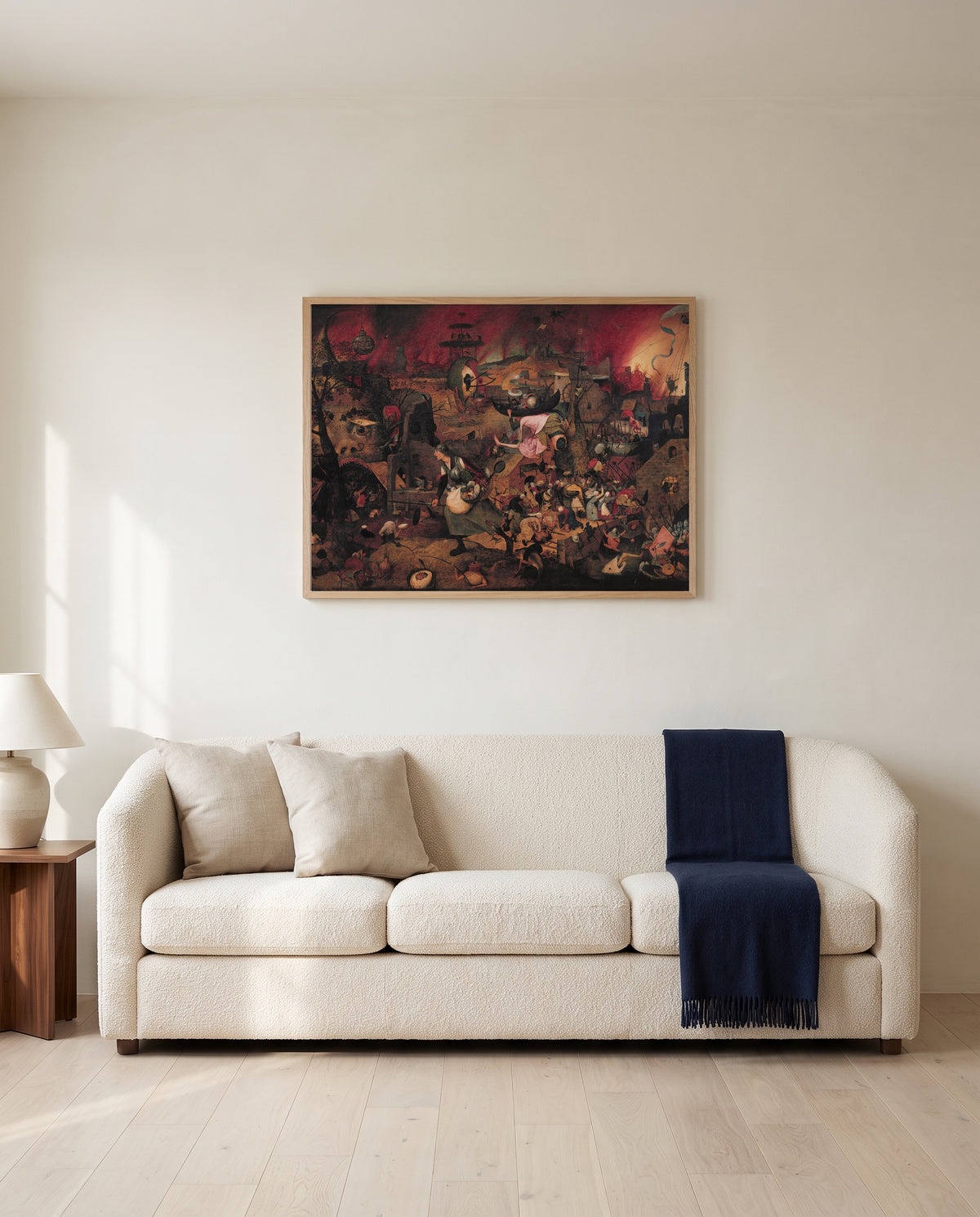 Dull Gret by Pieter Bruegel the Elder framed in natural oak above a cream sofa in a warm living room