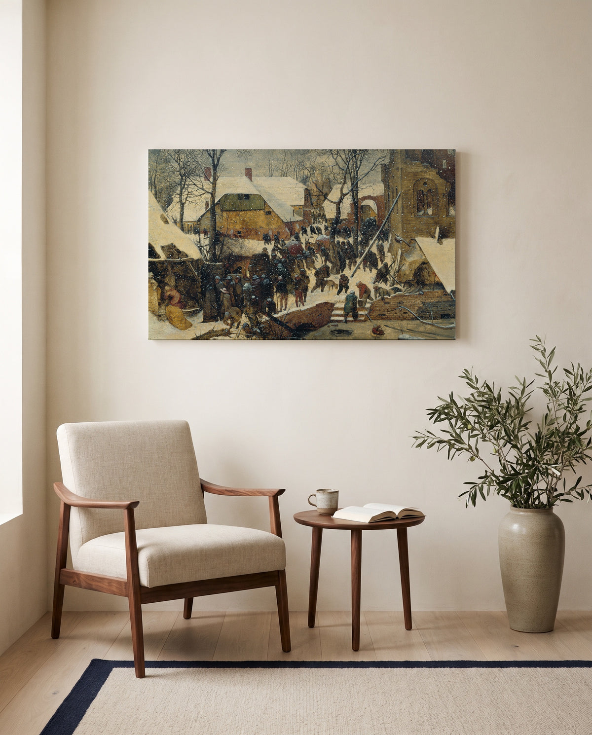 Adoration in the Snow by Pieter Bruegel the Elder as a stretched canvas above a linen lounge chair in a reading corner