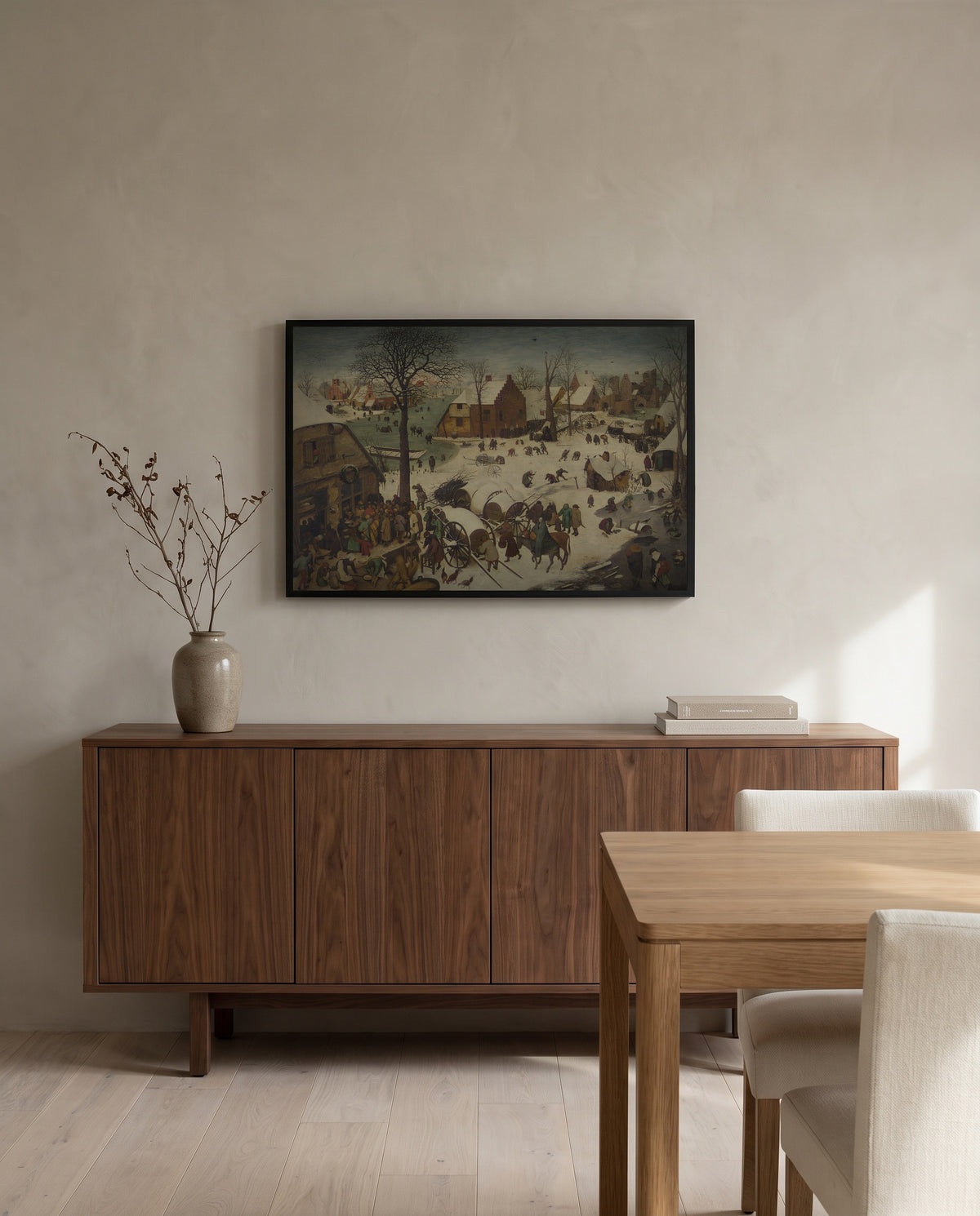 The Census at Bethlehem by Pieter Bruegel the Elder in a black frame above a walnut sideboard in a dining room
