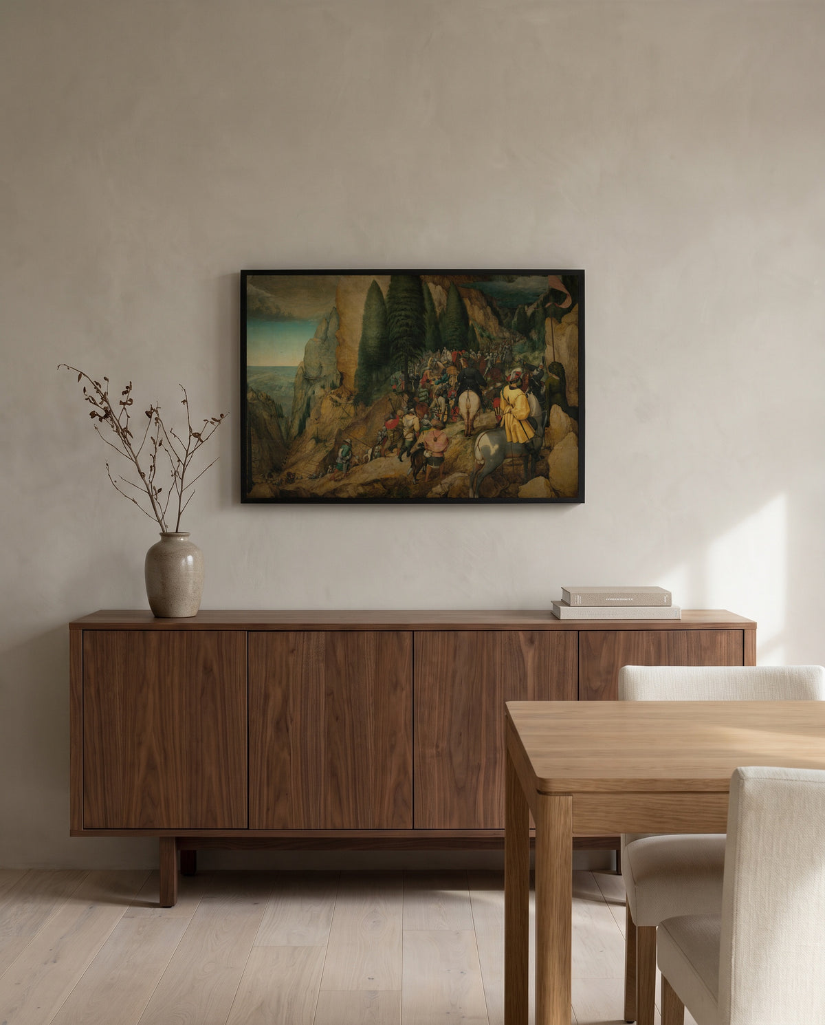 The Conversion of Paul by Pieter Bruegel the Elder in a black frame above a walnut sideboard in a dining room