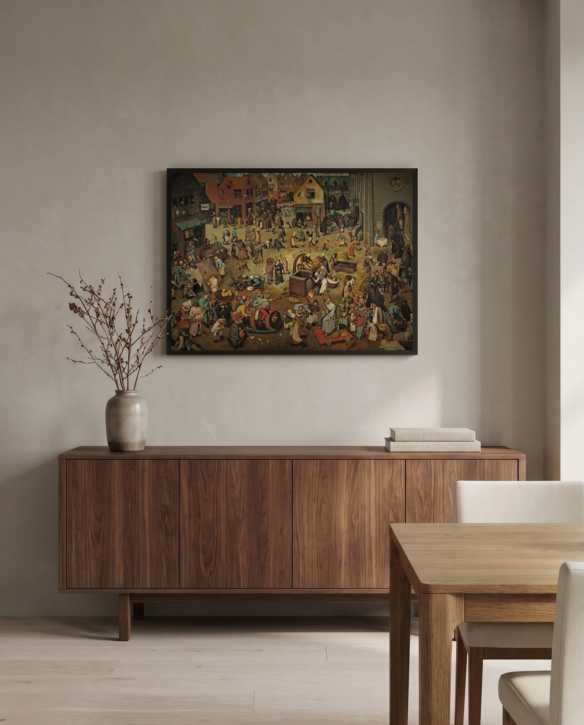Carnival and Lent by Pieter Bruegel the Elder in a black frame above a walnut sideboard in a dining room