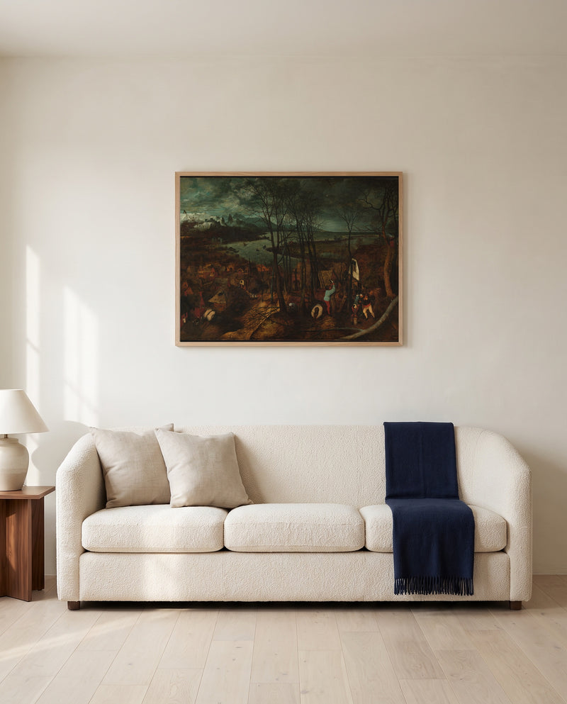 The Gloomy Day by Pieter Bruegel the Elder framed in natural oak above a cream sofa in a warm living room