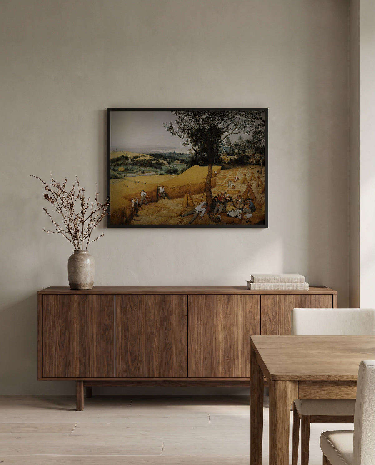 The Harvesters by Pieter Bruegel the Elder in a black frame above a walnut sideboard in a dining room