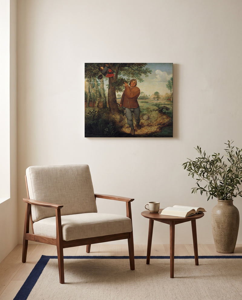 The Nest Robber by Pieter Bruegel the Elder as a stretched canvas above a linen lounge chair in a reading corner