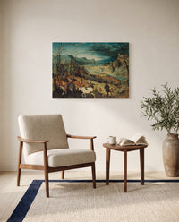 The Return of the Herd by Pieter Bruegel the Elder as a stretched canvas above a linen lounge chair in a reading corner