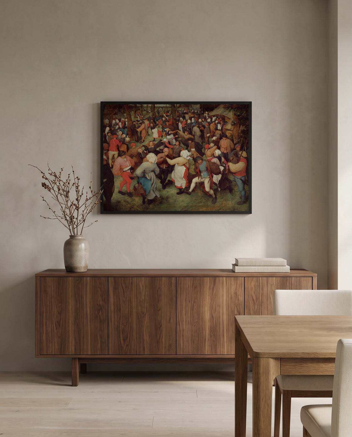 The Wedding Dance by Pieter Bruegel the Elder in a black frame above a walnut sideboard in a dining room