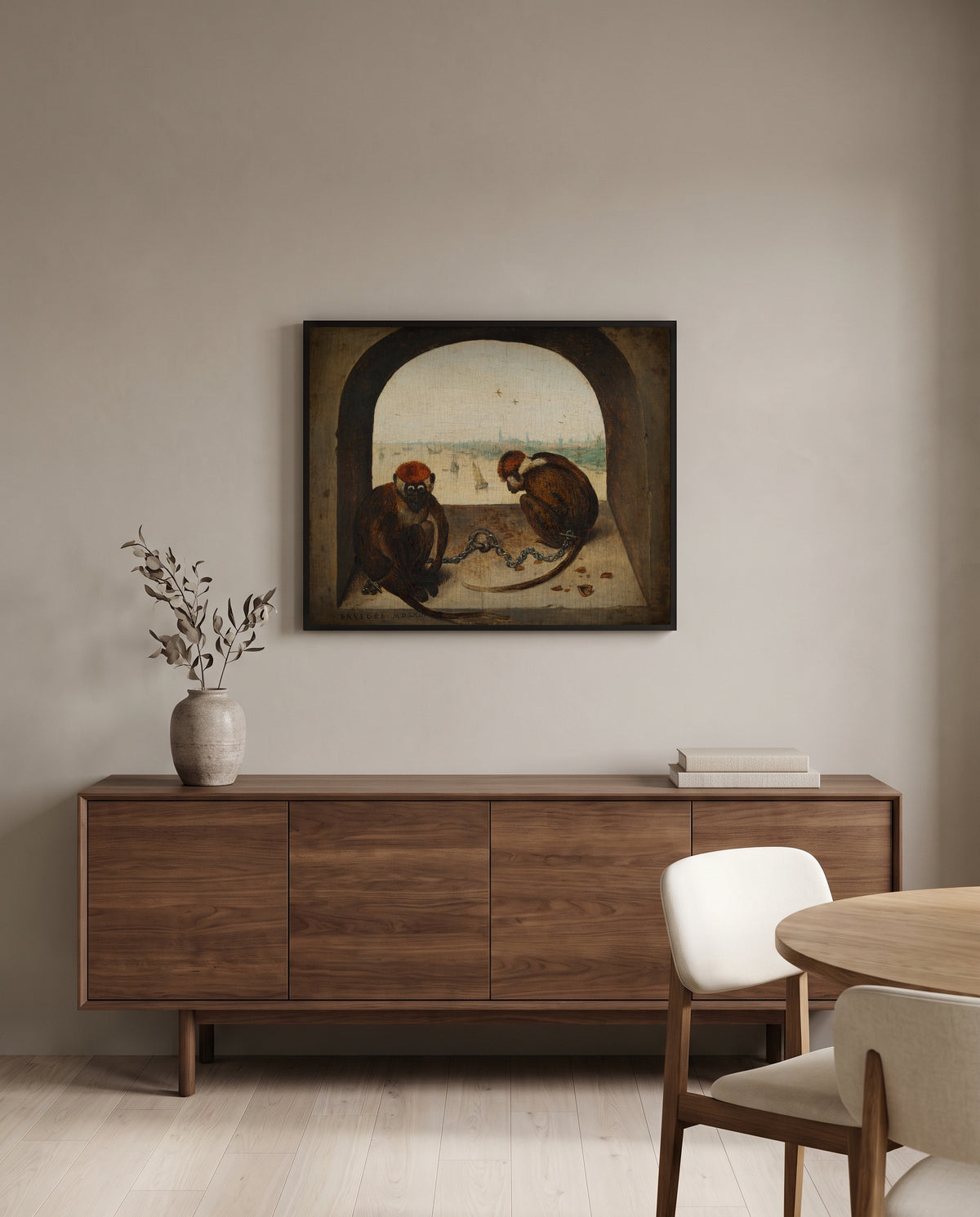 Two Chained Monkeys by Pieter Bruegel the Elder in a black frame above a walnut sideboard in a dining room