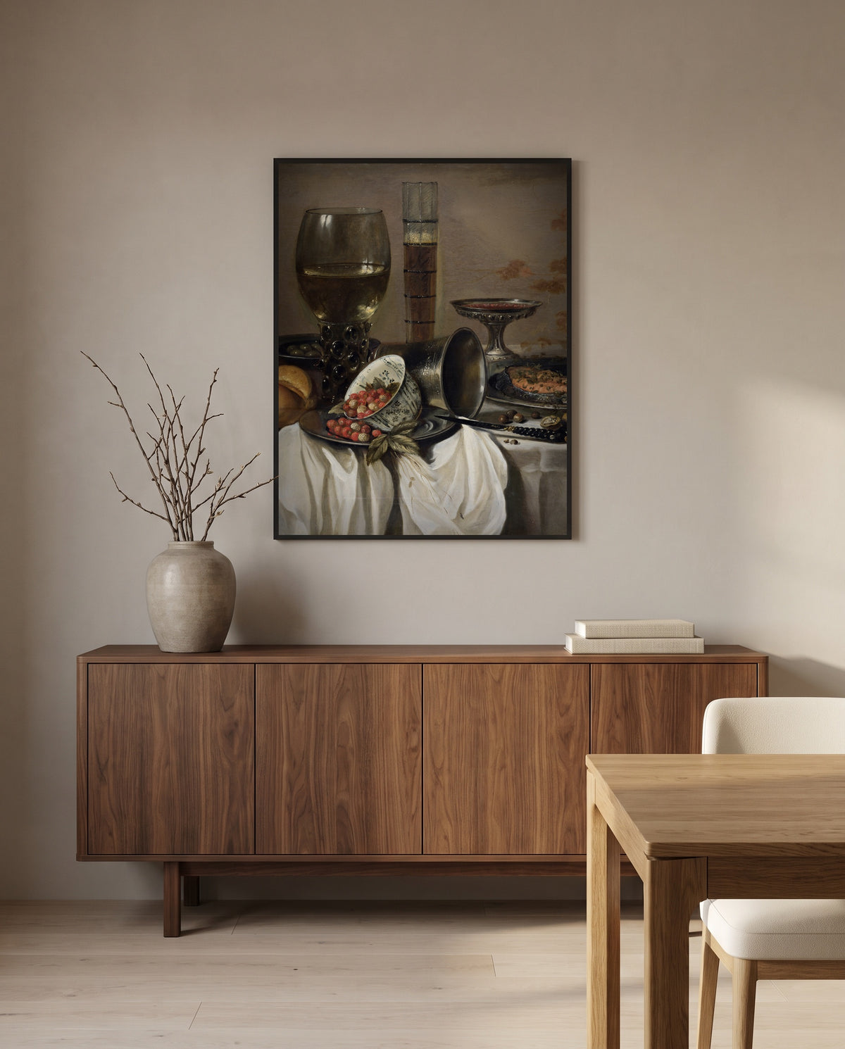 Drinking Vessels by Pieter Claesz in a black frame above a walnut sideboard in a dining room