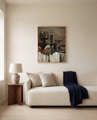 Drinking Vessels by Pieter Claesz framed in natural oak above a cream sofa in a warm living room