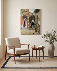 Courtyard in Delft by Pieter de Hooch as a stretched canvas above a linen lounge chair in a reading corner