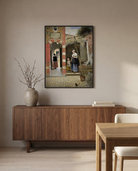 Courtyard in Delft by Pieter de Hooch in a black frame above a walnut sideboard in a dining room