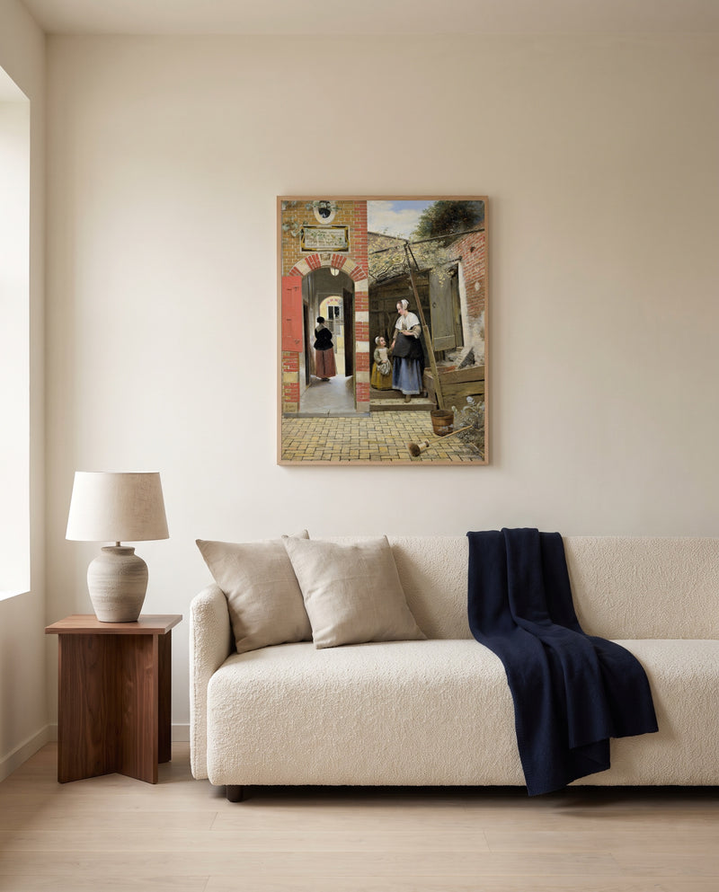 Courtyard in Delft by Pieter de Hooch framed in natural oak above a cream sofa in a warm living room