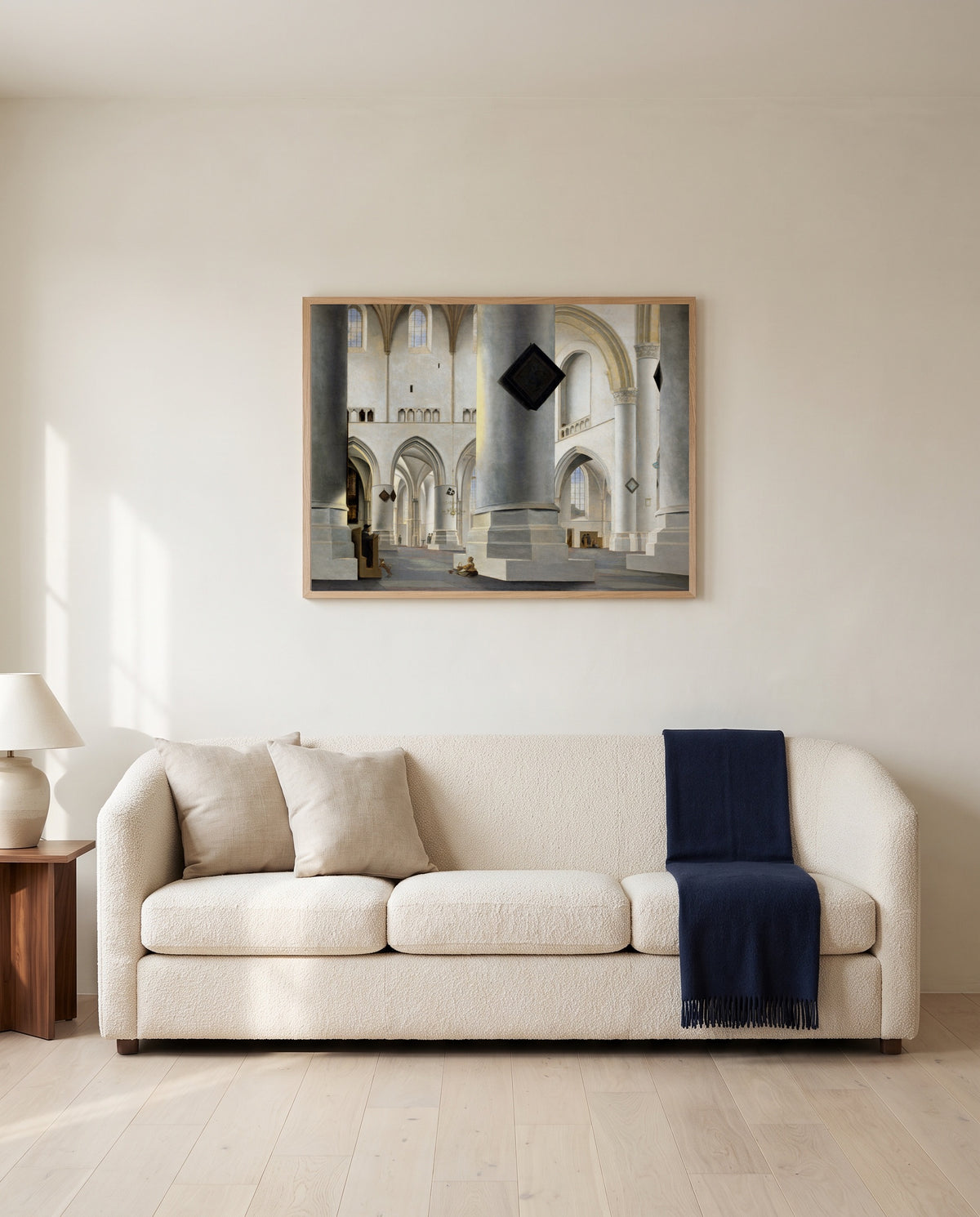 Grote Kerk, Haarlem by Pieter Saenredam framed in natural oak above a cream sofa in a warm living room