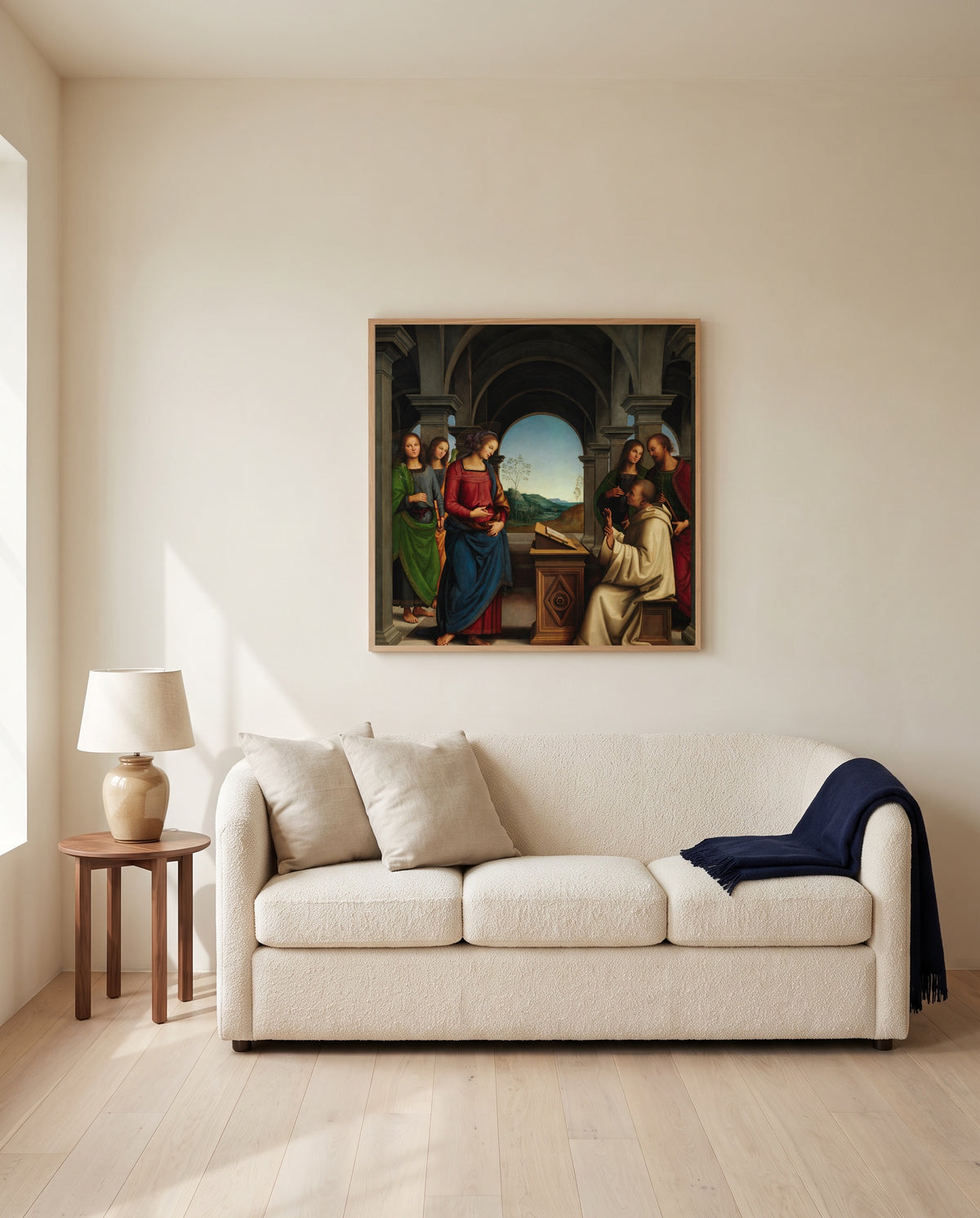 Vision of Saint Bernard by Pietro Perugino framed in natural oak above a cream sofa in a warm living room
