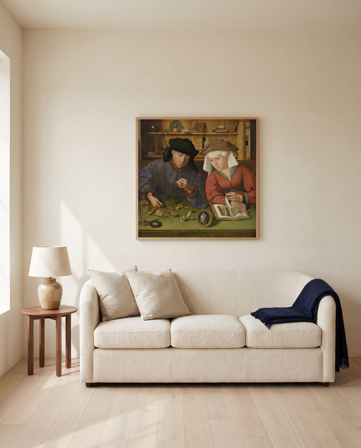 Moneylender and His Wife by Quentin Massys framed in natural oak above a cream sofa in a warm living room