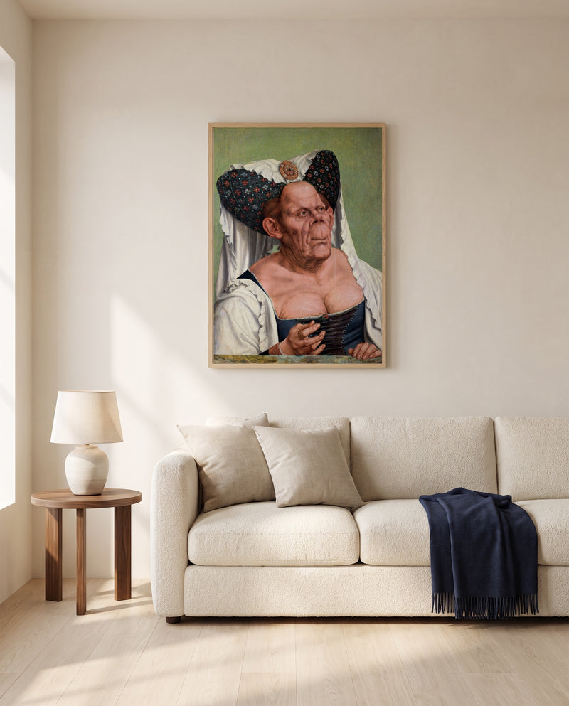 The Ugly Duchess by Quentin Massys framed in natural oak above a cream sofa in a warm living room