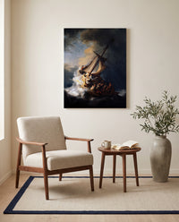 The Storm on the Sea of Galilee by Rembrandt as a stretched canvas above a linen lounge chair in a reading corner