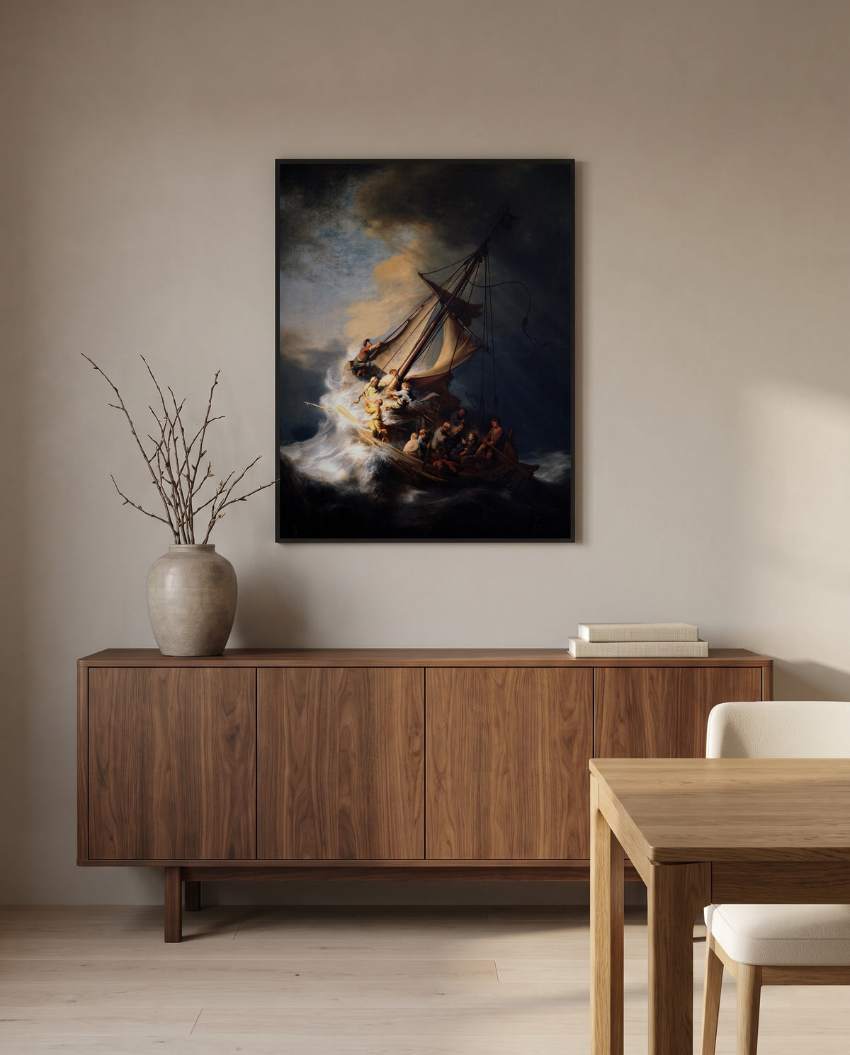The Storm on the Sea of Galilee by Rembrandt in a black frame above a walnut sideboard in a dining room
