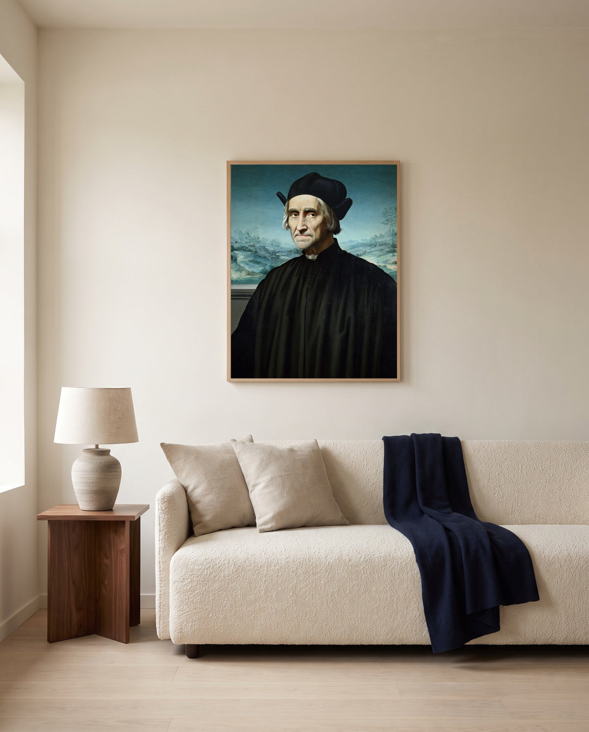 Girolamo Benivieni by Ridolfo Ghirlandaio framed in natural oak above a cream sofa in a warm living room