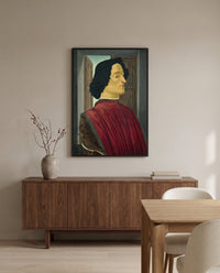 Giuliano de’ Medici by Sandro Botticelli in a black frame above a walnut sideboard in a dining room