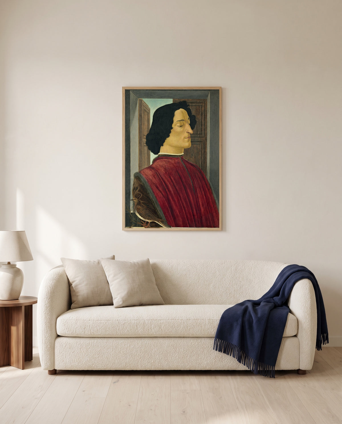 Giuliano de’ Medici by Sandro Botticelli framed in natural oak above a cream sofa in a warm living room