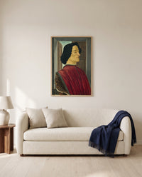 Giuliano de’ Medici by Sandro Botticelli framed in natural oak above a cream sofa in a warm living room