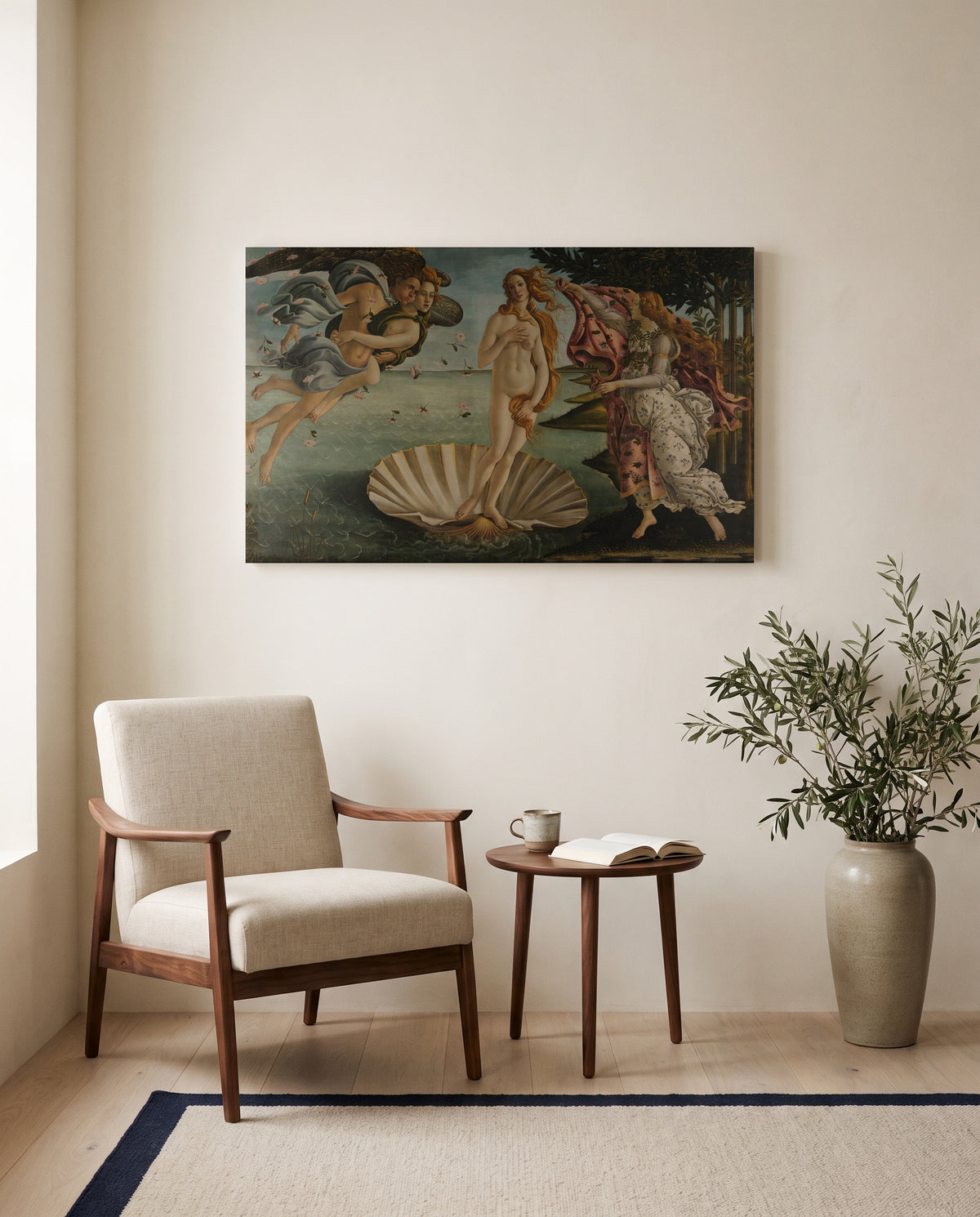 The Birth of Venus by Sandro Botticelli as a stretched canvas above a linen lounge chair in a reading corner