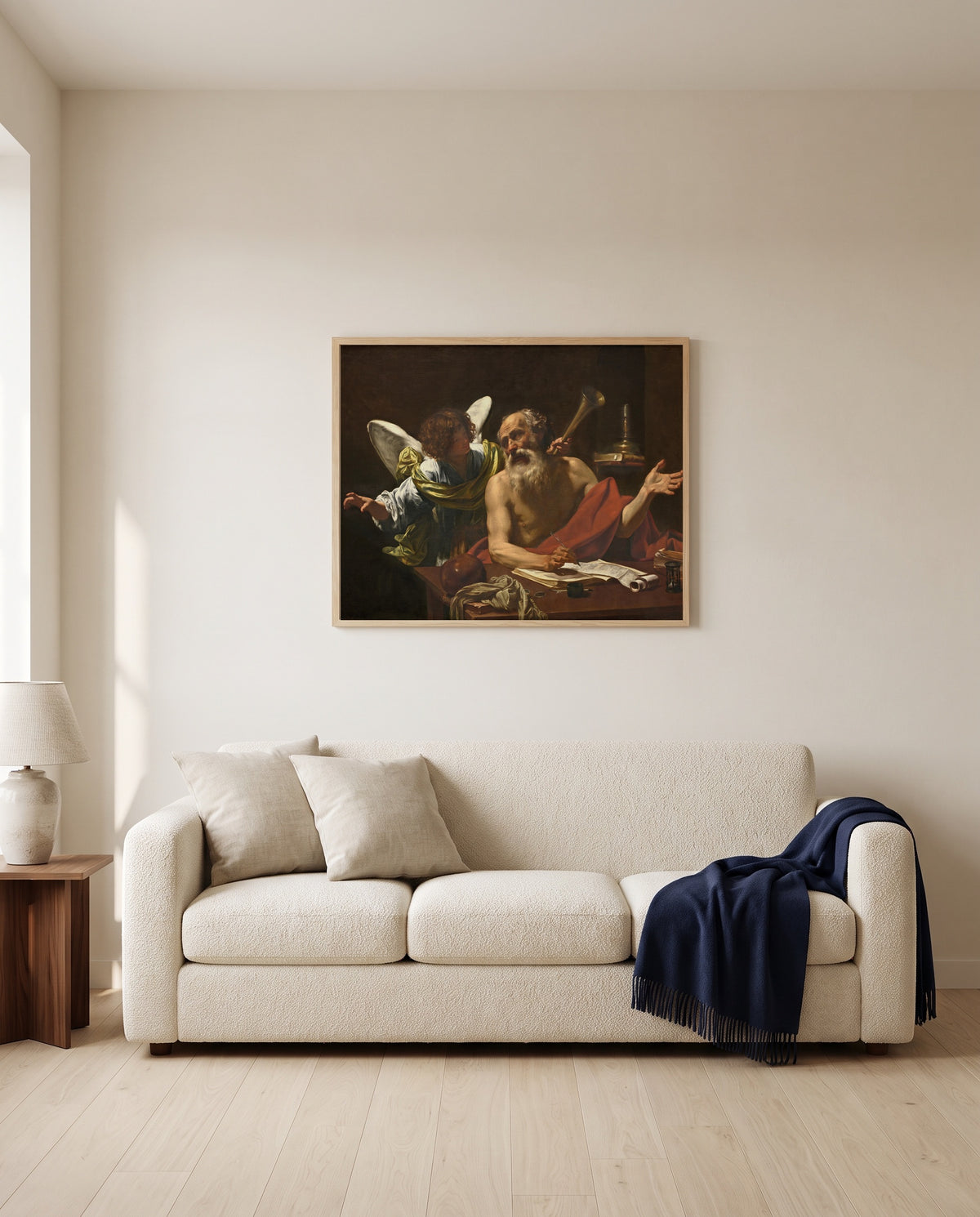 Saint Jerome and the Angel by Simon Vouet framed in natural oak above a cream sofa in a warm living room